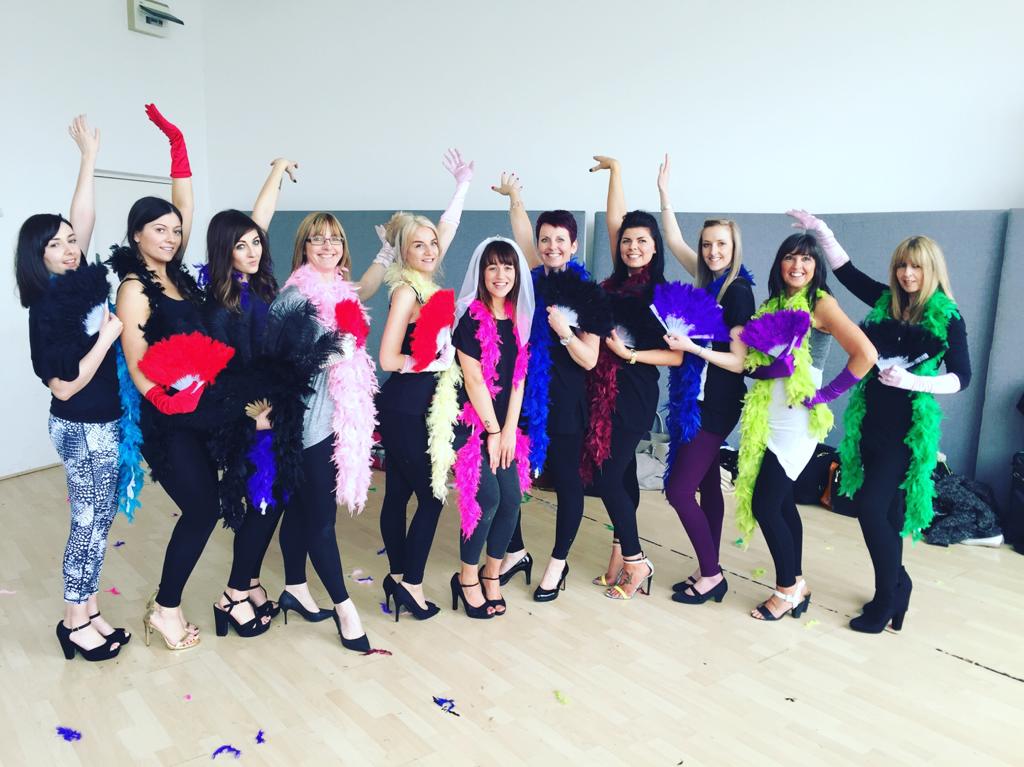 Burlesque hen party group with colorful feather boas and fans celebrating in Manchester